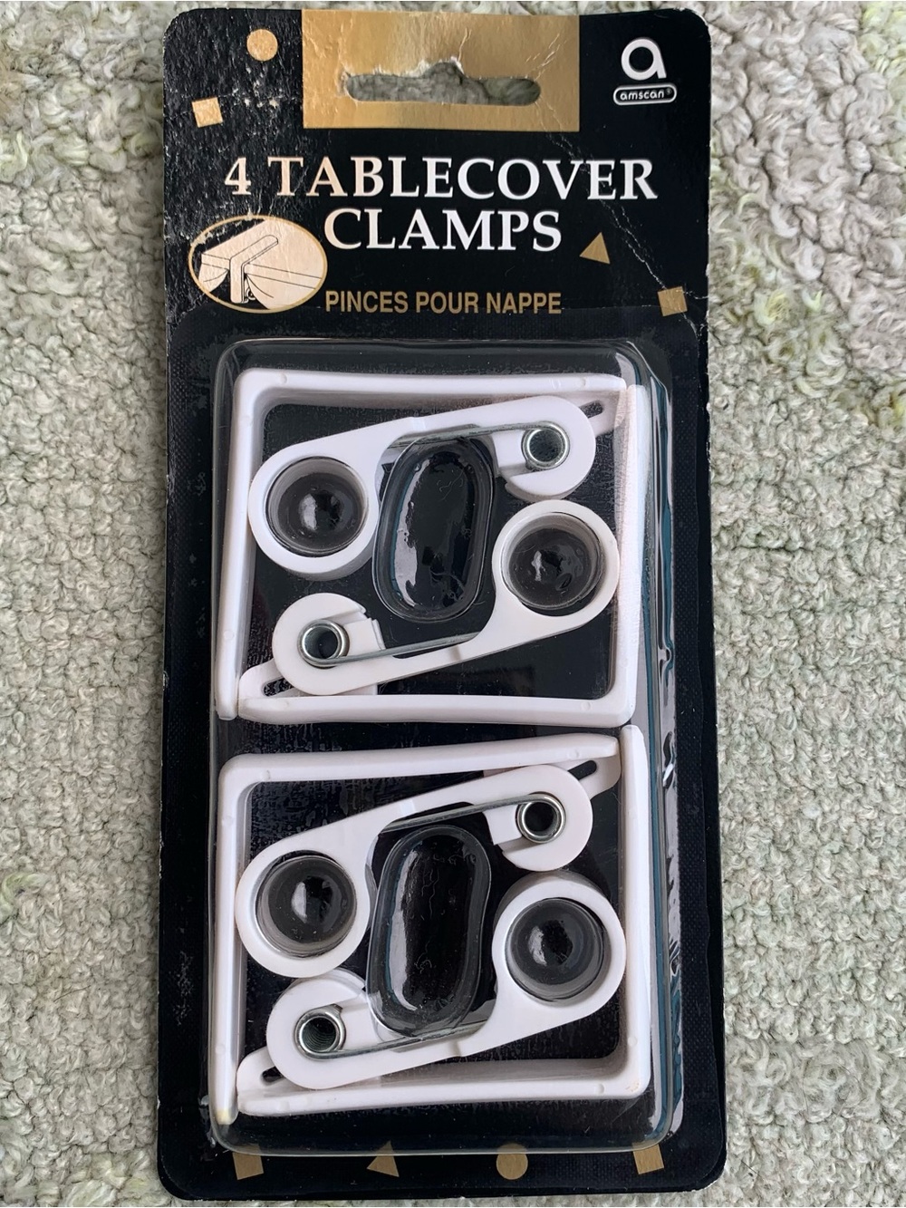 pack of four white Amscan tablecover clamps